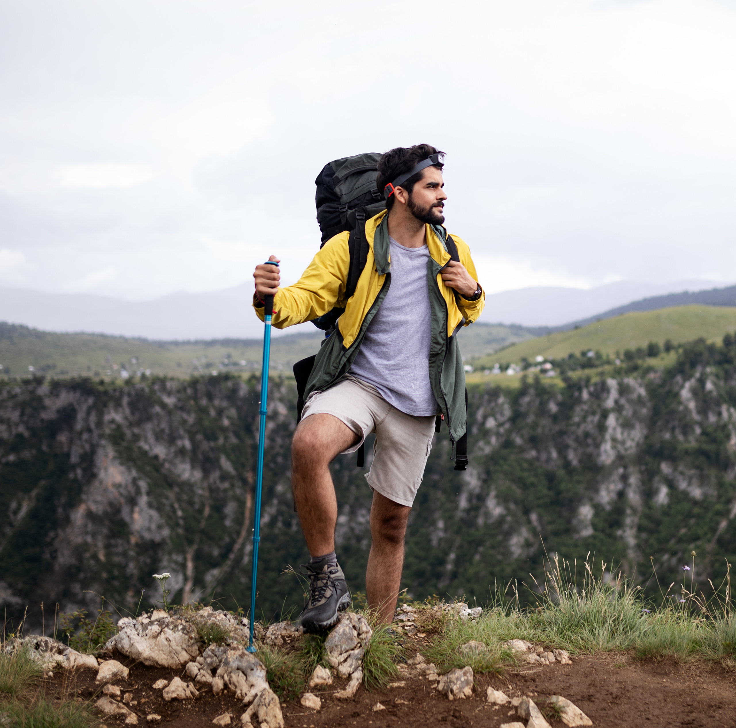 young-man-traveling-with-backpack-hiking-in-mounta